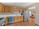 Updated kitchen with stainless steel appliances, oak wood cabinetry and durable vinyl flooring at 3035 Landington Way, Duluth, GA 30096