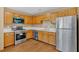 Bright kitchen featuring stainless steel appliances, wood cabinets and laminate floors at 3035 Landington Way, Duluth, GA 30096
