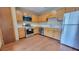 Well-maintained kitchen features stainless steel appliances, ample counter space and oak wood cabinetry at 3035 Landington Way, Duluth, GA 30096