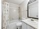 This bathroom has a shower/tub combo, toilet, sink with vanity, and a patterned shower curtain at 1205 Mcclelen Way, Decatur, GA 30033