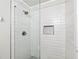Updated bathroom features a glass-enclosed shower with white subway tile and a built-in shelf at 1205 Mcclelen Way, Decatur, GA 30033