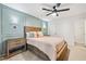 This bedroom has a ceiling fan, a bed, nightstands, light sconces, and carpeted floors at 1205 Mcclelen Way, Decatur, GA 30033