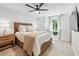 This bedroom boasts a ceiling fan, carpet floors, a wooded bed frame, and a view of outside at 1205 Mcclelen Way, Decatur, GA 30033