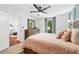 This bedroom features carpet floors, a ceiling fan, wooded furniture, and a view of the living room at 1205 Mcclelen Way, Decatur, GA 30033