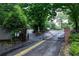 Gated community entrance with brick pillars and mature landscaping for added security at 1205 Mcclelen Way, Decatur, GA 30033