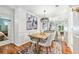 The dining room includes a modern light fixture, seating for four, and an adjacent living space at 1205 Mcclelen Way, Decatur, GA 30033