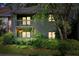 Two-story condo with brick accents and a covered balcony surrounded by lush landscaping at dusk at 1205 Mcclelen Way, Decatur, GA 30033