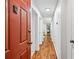 Inviting hallway with hardwood floors leading to a bedroom with a guitar and light-filled window at 1205 Mcclelen Way, Decatur, GA 30033