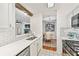 Open kitchen featuring quartz countertops, stainless appliances, and convenient access to the dining area at 1205 Mcclelen Way, Decatur, GA 30033