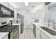 Well-lit kitchen featuring stainless steel appliances, white cabinetry, and a clean, functional design at 1205 Mcclelen Way, Decatur, GA 30033