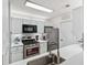 The modern kitchen features white cabinetry, steel appliances and plenty of counter space at 1205 Mcclelen Way, Decatur, GA 30033