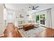 Bright living room with hardwood floors, a ceiling fan, and sliding door to the balcony at 1205 Mcclelen Way, Decatur, GA 30033