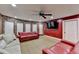 Basement featuring tile flooring, red accent walls, a stone wall and recessed lighting at 149 Stargrass Way, Grayson, GA 30017