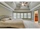Spacious bedroom featuring a tray ceiling, carpet flooring, and natural lighting at 149 Stargrass Way, Grayson, GA 30017