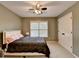 Comfortable bedroom with neutral walls, ceiling fan, and closet at 149 Stargrass Way, Grayson, GA 30017