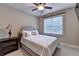 Comfortable bedroom featuring a plush bed, soft lighting, and a window overlooking the serene outdoors at 149 Stargrass Way, Grayson, GA 30017