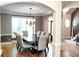 Dining room featuring hardwood floors, decorative chandelier, and natural light at 149 Stargrass Way, Grayson, GA 30017