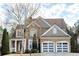Stunning two-story home featuring a stone and siding facade and a two-car garage with modern doors at 149 Stargrass Way, Grayson, GA 30017