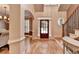 Spacious foyer with hardwood floors, staircase, and a decorative front door at 149 Stargrass Way, Grayson, GA 30017