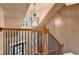 Staircase featuring iron railings, wood steps, with a chandelier hanging above at 149 Stargrass Way, Grayson, GA 30017