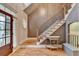 Bright foyer boasts hardwood floors, staircase, and a decorative table at 149 Stargrass Way, Grayson, GA 30017