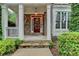 Charming front porch with stone facade, white pillars, and well-manicured landscaping at 149 Stargrass Way, Grayson, GA 30017