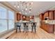 Well-equipped kitchen with wood cabinets, stainless steel appliances and bar-stool seating at a spacious counter at 149 Stargrass Way, Grayson, GA 30017