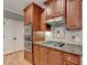 Close-up of kitchen showcasing stainless steel appliances, granite countertops, and rich wood cabinetry at 149 Stargrass Way, Grayson, GA 30017