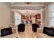 Open-concept living and kitchen area with a central island, pendant lighting and hardwood floors throughout at 149 Stargrass Way, Grayson, GA 30017