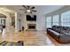 Spacious living room features hardwood floors, stone fireplace, and a large window with plenty of natural light at 149 Stargrass Way, Grayson, GA 30017