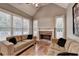 Inviting living room boasts a vaulted ceiling, stone fireplace, and large windows providing natural light at 149 Stargrass Way, Grayson, GA 30017