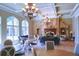 Elegant lounge area boasting coffered ceilings, stone fireplaces, arched windows, and stylish seating arrangements at 149 Stargrass Way, Grayson, GA 30017