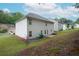 Wide backyard view with a patio, picnic table, and well-maintained lawn and landscaping at 2272 Gateway Trl, Ellenwood, GA 30294