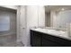 Bathroom showcasing double sinks with granite countertops, modern fixtures, and convenient access to the closet at 2272 Gateway Trl, Ellenwood, GA 30294
