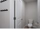 Neutral bathroom with toilet, coat hooks and and gray toned plank flooring at 2272 Gateway Trl, Ellenwood, GA 30294