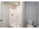 Bathroom showcasing a tiled shower with neutral tones, modern fixtures, and convenient access to the toilet at 2272 Gateway Trl, Ellenwood, GA 30294