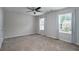 Spacious bedroom featuring two windows, ceiling fan, and neutral decor at 2272 Gateway Trl, Ellenwood, GA 30294