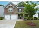 Charming two-story brick home with a well-manicured lawn and two-car garage at 2272 Gateway Trl, Ellenwood, GA 30294