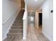 Inviting hallway with a staircase and wood-look floors at 2272 Gateway Trl, Ellenwood, GA 30294