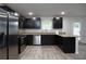 Modern kitchen features stainless steel appliances, granite countertops and dark cabinets at 2272 Gateway Trl, Ellenwood, GA 30294