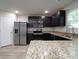 Beautiful kitchen boasts granite countertops, stainless appliances, and ample cabinet space at 2272 Gateway Trl, Ellenwood, GA 30294
