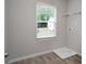 Bright laundry room with vinyl flooring, window, and storage shelf at 2272 Gateway Trl, Ellenwood, GA 30294