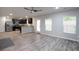 Open-concept living area with stainless steel appliances, lots of light and wood-look floors at 2272 Gateway Trl, Ellenwood, GA 30294