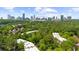 Aerial view of a lush green community with city skyline in the distance at 25305 Plantation Ne Dr, Atlanta, GA 30324