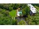 Aerial view of lush green community with pool, pond, and manicured green spaces at 25305 Plantation Ne Dr, Atlanta, GA 30324