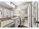 Bathroom features granite countertops, white cabinets, and a view into the next bathroom at 25305 Plantation Ne Dr, Atlanta, GA 30324
