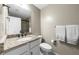 This bathroom features a granite countertop, dark hardware, and a shower with a glass door at 25305 Plantation Ne Dr, Atlanta, GA 30324