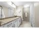 Bathroom with granite counters, white cabinets, and a shower/tub combo at 25305 Plantation Ne Dr, Atlanta, GA 30324