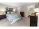 Neutral bedroom featuring carpet, a king sized bed, and an attached bathroom at 25305 Plantation Ne Dr, Atlanta, GA 30324