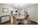 Dining room with seating for four, wood floors, and views to the living room and kitchen at 25305 Plantation Ne Dr, Atlanta, GA 30324